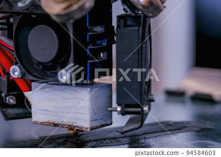 Modern 3D printer machine printing plastic model - close up 94584603