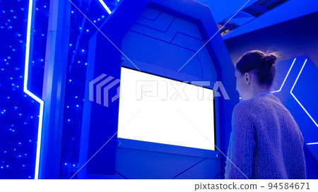 White screen concept - woman looking at blank white display kiosk at exhibition 94584671