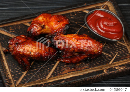 Barbecue chicken buffalo wings sauce on wood 94586047
