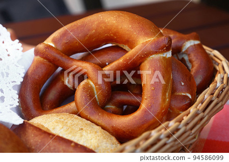 Close up pretzel bread and buns in basket 94586099