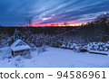 Forest cabin and trees in winter sunset. Wooden hut in the snow. forest on the evening sky background 94586961