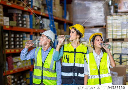 Worker drinking water in factory site. 94587130