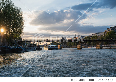 Sunset at Pont des Arts, Paris, France or Passerelle des Arts is a pedestrian bridge that has an international reputation as the bridge of romance. 94587588