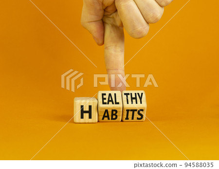 Healthy habits symbol. Concept words Healthy habits on wooden cubes. Doctor hand. Beautiful orange table orange background. Medical and healthy habits concept. Copy space. 94588035