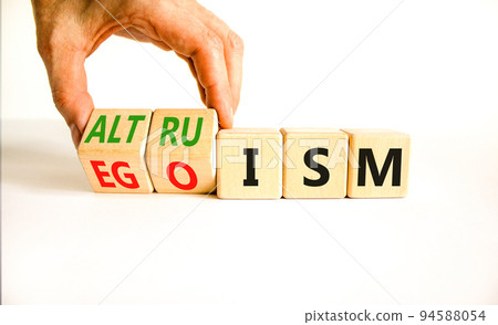Altruism or egoism symbol. Concept words Egoism and Altruism on wooden cubes. Psychologist hand. Beautiful white table white background. Business psychological altruism or egoism concept. Copy space 94588054