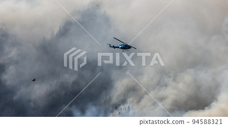 Wildfire Service Helicopter flying over BC Forest Fire and Smoke on the mountain near Hope Wildfire Service Helicopter flying over BC Forest Fire and Smoke on the mountain near Hope 94588321