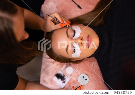 Female Client Going Through Eyelash Extension Procedure Female Client Going Through Eyelash Extension Procedure 94588739