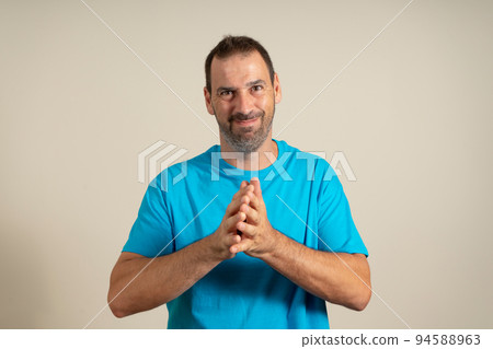 Photo of satisfied person arms palms together look interested empty space isolated on beige color background. 94588963