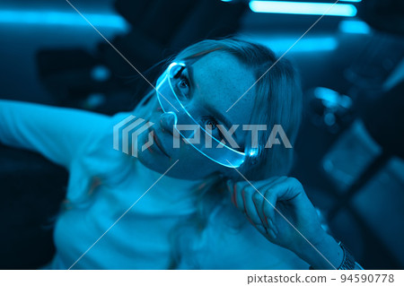 Young woman in neon glasses. Cyberpunk style. Young woman in neon glasses. Cyberpunk style. 94590778