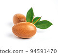Argan nuts with green leaves on isolated white background. Moroccan Argania Spinosa seeds for the production of oil 94591470