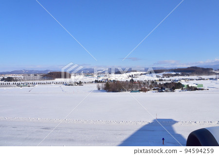 Asahikawa Airport in winter and aerial view after departure 94594259