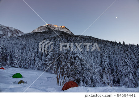 Yatsugatake mountain range Amidadake and the moon in the morning sun seen from the ascetic hut Yatsugatake mountain range Amidadake and the moon in the morning sun seen from the ascetic hut 94594441