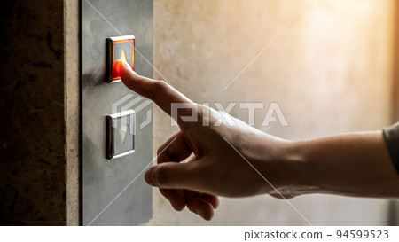 woman finger presses the elevator up button upper high level floor. 94599523