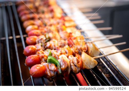 Barbecue skewers with vegetables  on the grill 94599524