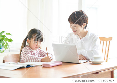 Mother working from home and daughter studying 94599707