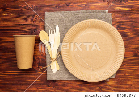 Environmentally friendly, disposable, cardboard, paper utensils, spoons, forks on beige background. Zero waste Environmentally friendly, disposable, cardboard, paper utensils, spoons, forks on beige background. Zero waste 94599878