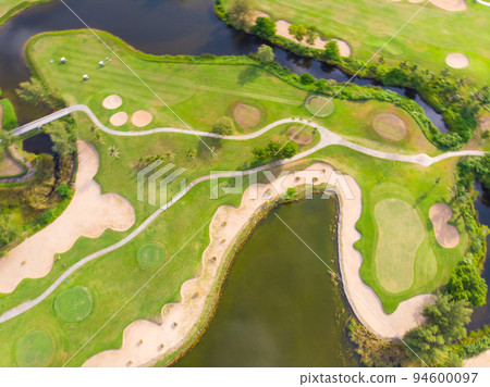 Golf course aerial view green grass near sea beach 94600097