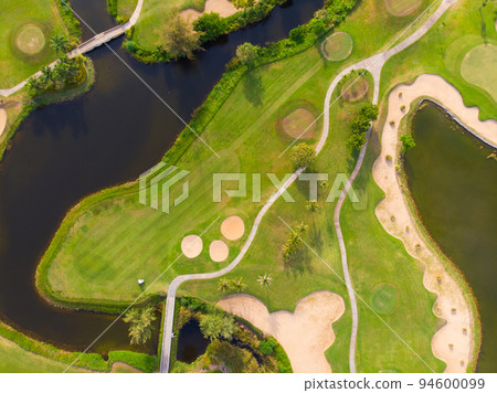 Golf course aerial view green grass near sea beach 94600099