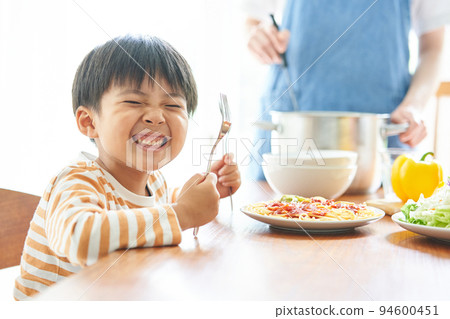 Mother and boy preparing meals Mother and boy preparing meals 94600451