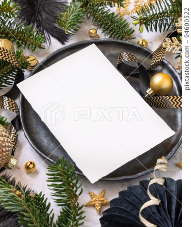 Black and golden Christmas Table setting with ornaments and fir tree branches. Menu card Mockup Black and golden Christmas Table setting with ornaments and fir tree branches. Menu card Mockup 94600522