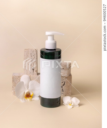 One pump bottle near white orchid flower and stones on light beige, Mockup 94600527
