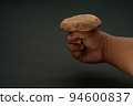 Hand holding shiitake copy space 94600837