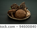 Autumn mushrooms (shiitake and oyster mushrooms) in a colander Copy space 94600840
