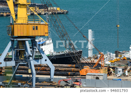 industrial seaport infrastructure, sea, cranes and raw materials, metal structures and ship, the concept of marine cargo transportation 94601793