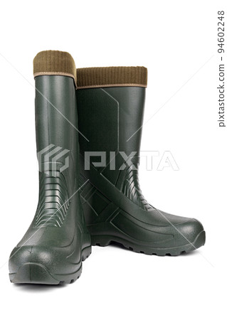 Green rubber boots with a warm toe on a white background. Green rubber boots with a warm toe on a white background. 94602248