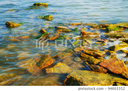 beautiful summer seascape, seashore on a bright day, stones and splashes of waves 94603352