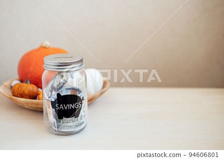 Save Money Thanksgiving day ideas, Savings, Thanksgiving on Budget. Glass mason jar piggy bank with dollars cash on Thanksgiving pumpkin decoration background Save Money Thanksgiving day ideas, Savings, Thanksgiving on Budget. Glass mason jar piggy bank with dollars cash on Thanksgiving pumpkin decoration background 94606801
