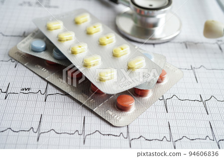 Stethoscope on electrocardiogram (ECG) with drug, heart wave, heart attack, cardiogram report. Stethoscope on electrocardiogram (ECG) with drug, heart wave, heart attack, cardiogram report. 94606836