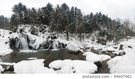 A small active waterfall. Clean mountain stream, snowy winter landscape, wildlife background A small active waterfall. Clean mountain stream, snowy winter landscape, wildlife background 94607462
