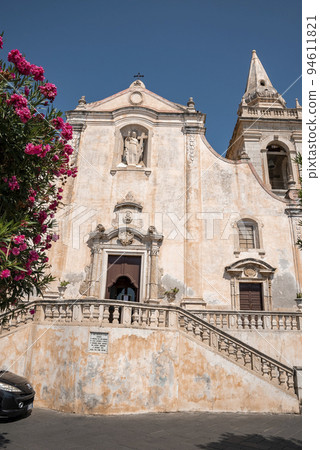 Baroque style Chiesa di San Giuseppe Cathedral with blue sky in background. Beautiful majestic basilica at townsquare in ancient city. Famous tourist attraction by tree during summer. Baroque style Chiesa di San Giuseppe Cathedral with blue sky in background. Beautiful majestic basilica at townsquare in ancient city. Famous tourist attraction by tree during summer. 94611821