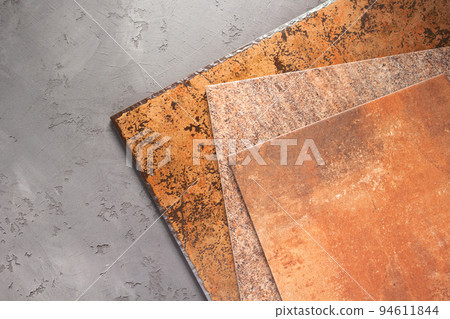 Tile samples at cement floor background texture. Concrete wall and tiles with 94611844