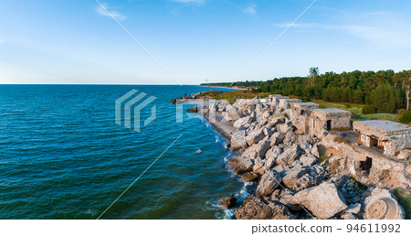Ruins of bunkers on the beach of the Baltic sea, part of an old fort in the former Soviet base Karosta in Liepaja, Latvia. Sunset landscape. Ruins of bunkers on the beach of the Baltic sea, part of an old fort in the former Soviet base Karosta in Liepaja, Latvia. Sunset landscape. 94611992