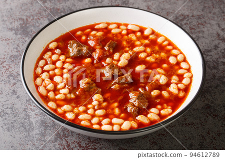 Turkish white bean stew with meat Etli kuru fasulye closeup in the plate. Horizontal Turkish white bean stew with meat Etli kuru fasulye closeup in the plate. Horizontal 94612789