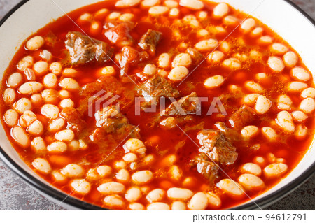 Spicy Turkish food Kuru Fasulye from beans with lamb in tomato sauce close-up in a bowl. horizontal Spicy Turkish food Kuru Fasulye from beans with lamb in tomato sauce close-up in a bowl. horizontal 94612791