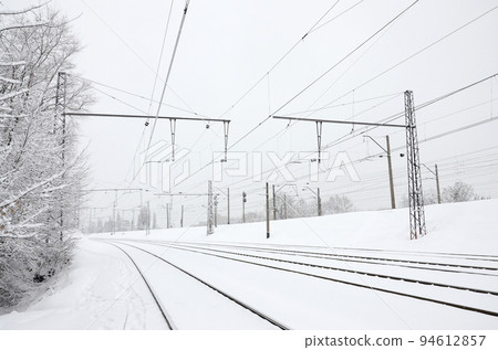 Winter railway landscape, Railway tracks in the snow-covered industrial country 94612857