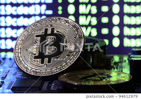 The digital process of cryptocurrency mining by using the GPUs. Bitcoins and video card on a working display and mining screen The digital process of cryptocurrency mining by using the GPUs. Bitcoins and video card on a working display and mining screen 94612979