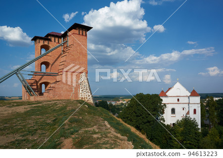 Ruins of Tower and Mindovg Castle on hill, Farnese Church of Transfiguration of the Lord in Novogrudok city, Grodno region, Belarus. 94613223