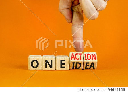 One idea and action symbol. Concept words One idea and One action on wooden cubes. Businessman hand. Beautiful orange table orange background. Business One idea and action concept. Copy space. One idea and action symbol. Concept words One idea and One action on wooden cubes. Businessman hand. Beautiful orange table orange background. Business One idea and action concept. Copy space. 94614166