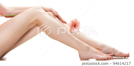 Healthy female Legs. Spa. Long woman legs and orchids isolated on white background. Skin care. Depilation. Epilation. Healthy female Legs. Spa. Long woman legs and orchids isolated on white background. Skin care. Depilation. Epilation. 94614217