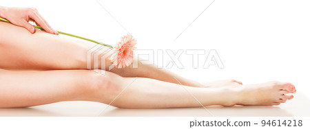 Healthy female Legs. Spa. Long woman legs and orchids isolated on white background. Skin care. Depilation. Epilation. Healthy female Legs. Spa. Long woman legs and orchids isolated on white background. Skin care. Depilation. Epilation. 94614218
