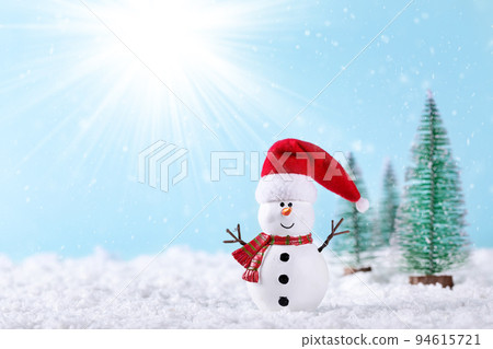 Christmas greeting card. Snowman and new year trees on snow over blue paper background 94615721