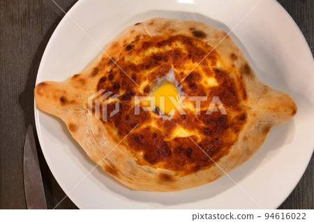 Ajarian khachapuri Georgian cheese pie with egg close Ajarian khachapuri Georgian cheese pie with egg close 94616022
