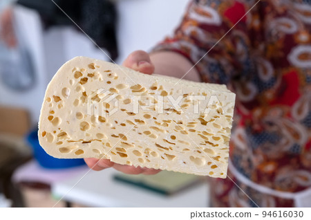 Homemade Caucasian cheese or Bryndza cut in slices at local market 94616030