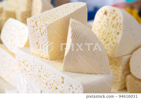Homemade Caucasian cheese or Bryndza cut in slices at local market Homemade Caucasian cheese or Bryndza cut in slices at local market 94616031