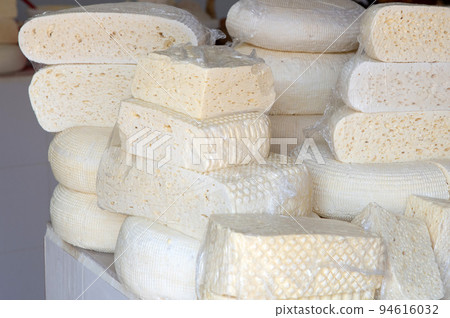 Homemade Caucasian cheese or Bryndza cut in slices at local market Homemade Caucasian cheese or Bryndza cut in slices at local market 94616032