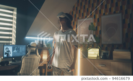Man at home wearing VR headset 94616679
